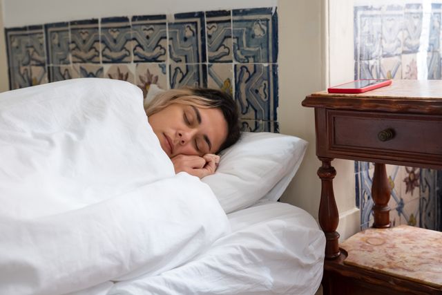 Woman sleeping comfortably in bed